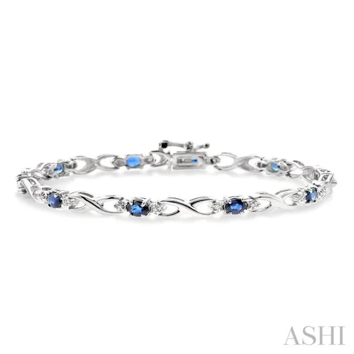 4×3 MM Oval Cut Sapphire and 1/10 Ctw Single Cut Diamond Bracelet in 10K White Gold