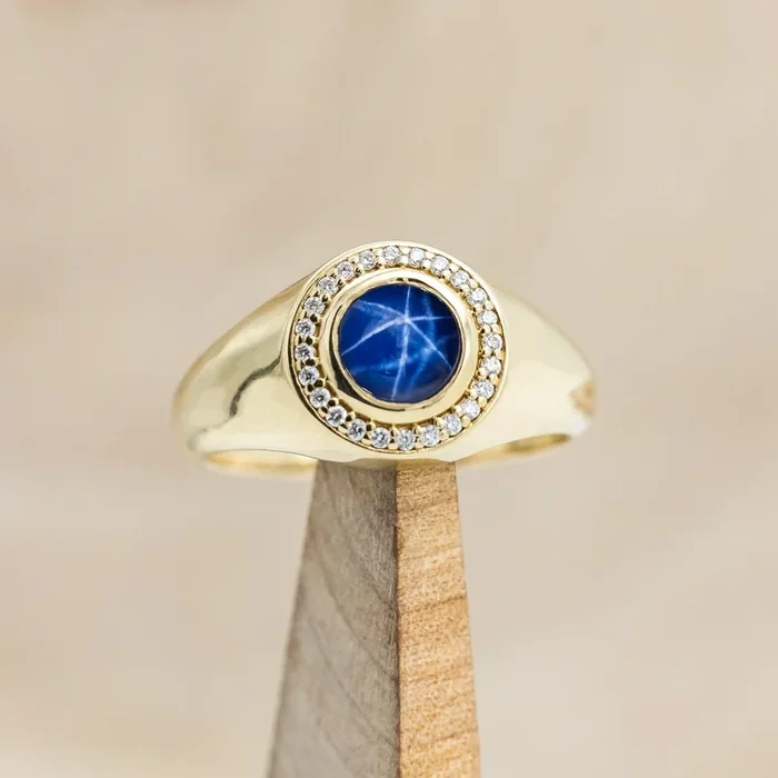 “ARLA” – ROUND CABOCHON CUT LAB-GROWN BLUE STAR SAPPHIRE ENGAGEMENT RING WITH A DIAMOND HALO