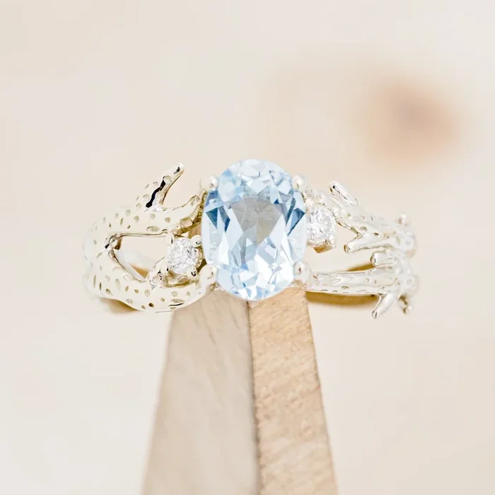 “ARTEMIS” – CORAL INSPIRED OVAL CUT SKY BLUE TOPAZ ENGAGEMENT RING WITH DIAMOND ACCENTS