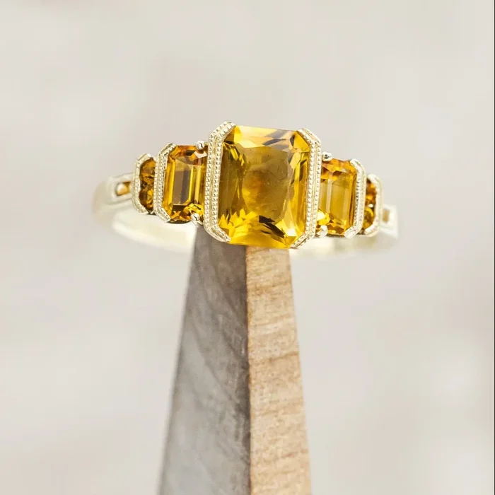 “HAZEL” – EMERALD CUT CITRINE ENGAGEMENT RING WITH CITRINE ACCENTS