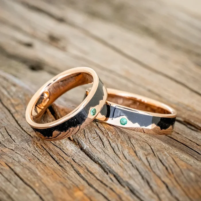 “HELIOS” – MATCHING SET OF JET STONE & GOLD MOUNTAIN RANGE WEDDING BANDS WITH A LAB GROWN EMERALD ACCENT