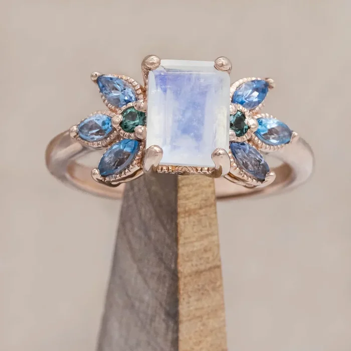 “MOONSHADOW” – EMERALD CUT MOONSTONE ENGAGEMENT RING WITH GREEN TOURMALINE & AQUAMARINE ACCENTS