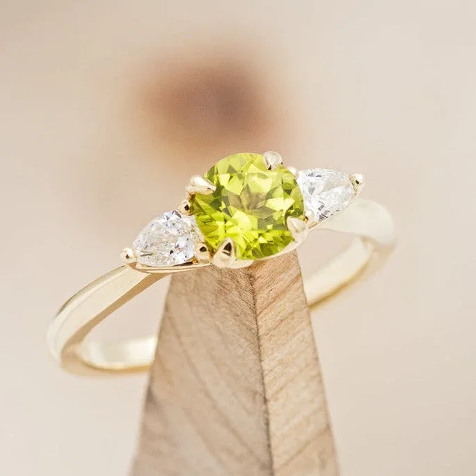 “PELE” – ROUND CUT PERIDOT ENGAGEMENT RING WITH DIAMOND ACCENTS
