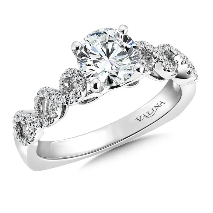 A continuous open diamond twist creates the infinity symbol. The lacey design is delicate and balanced.