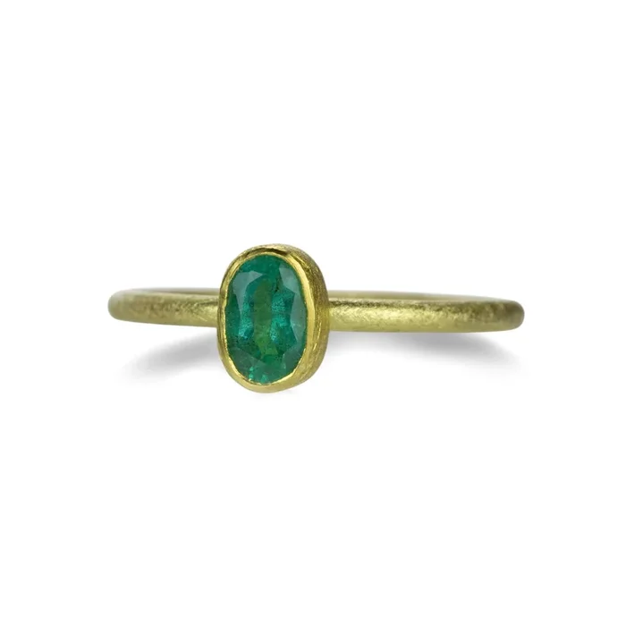Oval Bezel Set Faceted Emerald Ring